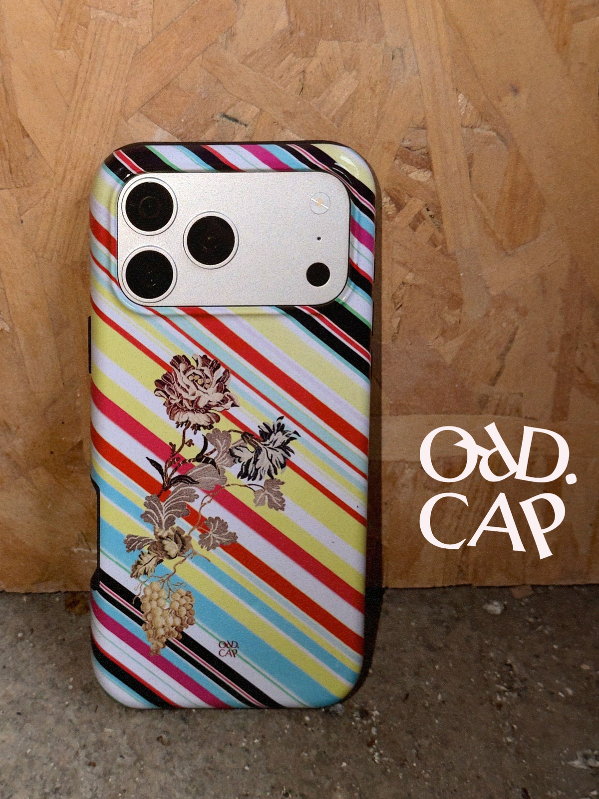 ORD.CAP Iced Aura gradient phone cases arranged on blue with a tomato