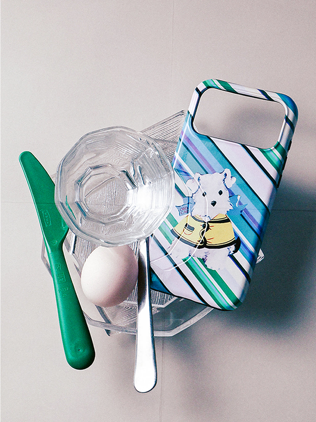 Dog on an Errand striped dog MagSafe phone case in a styled still life