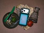 Night Window dark green gradient MagSafe phone case in a styled still life