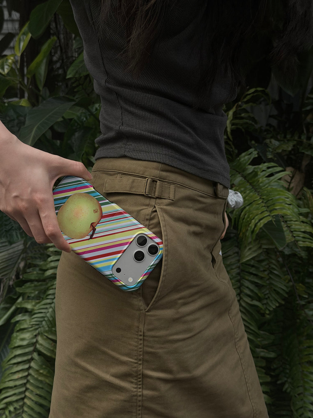 Apple for Later striped apple MagSafe phone case in a lifestyle setting