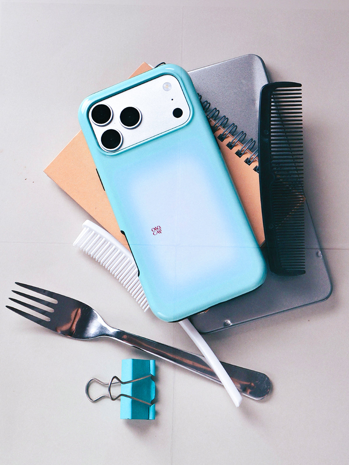 Mint Window aqua gradient MagSafe phone case with notebook, comb and cutlery