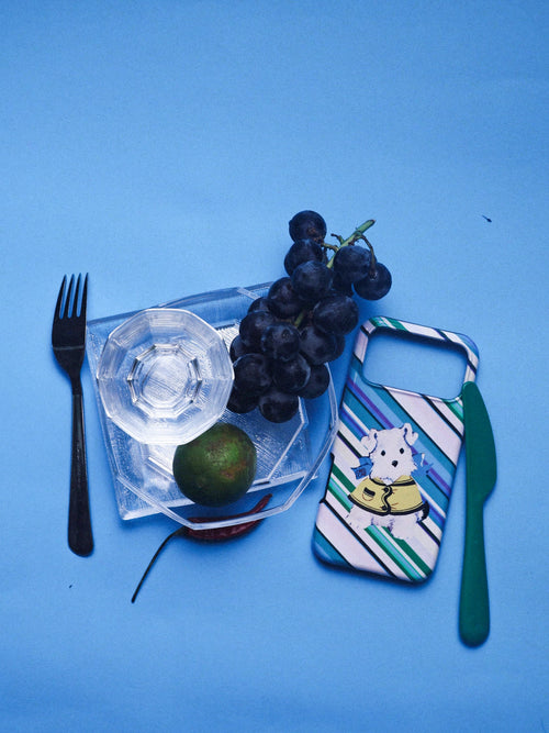 Dog on an Errand phone case arranged with tableware