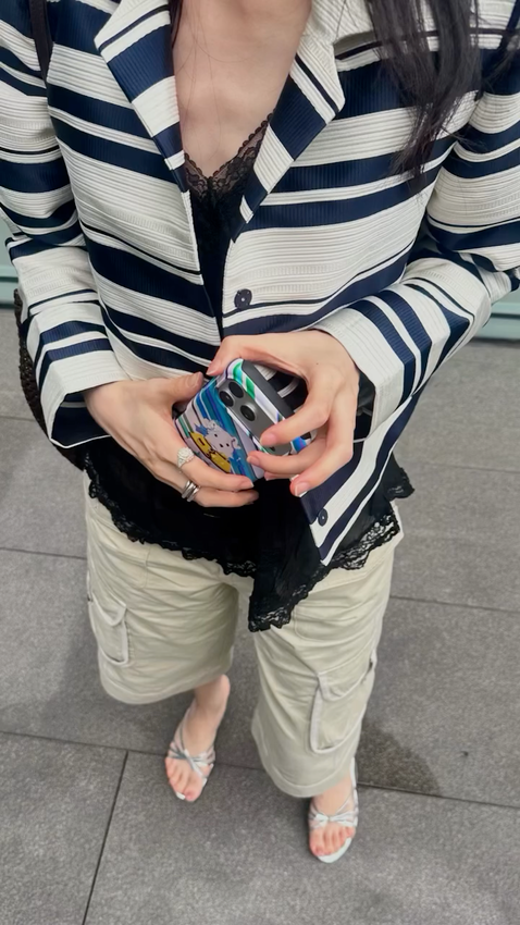 Striped outfit styled with an ORD.CAP phone case.