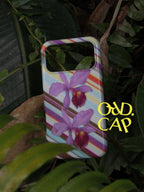Orchid at Dusk phone case photographed among leaves
