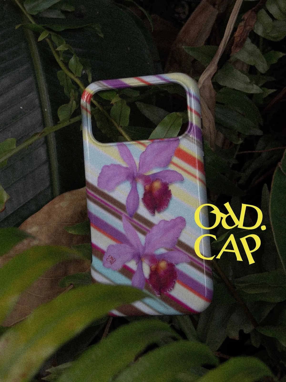 Orchid at Dusk phone case photographed among leaves